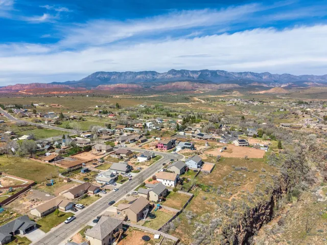 Residential area featuring a variety of single-family homes, paved streets, and undeveloped land