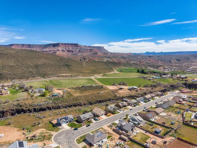 Expansive aerial view of a residential neighborhood with surrounding natural landscapes