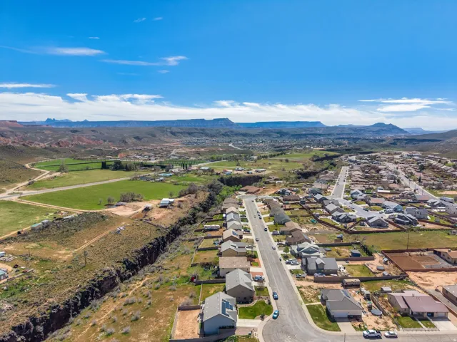 Expansive aerial view showcasing a residential neighborhood with surrounding natural landscapes