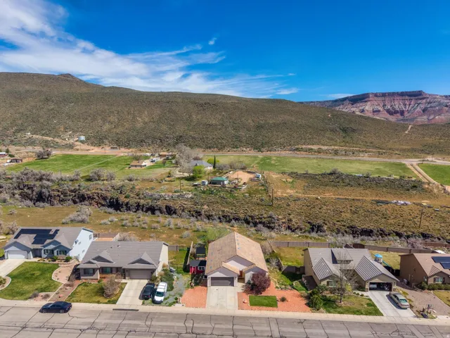 Single-story property with an attached garage, a paved driveway, and xeriscaped front yard