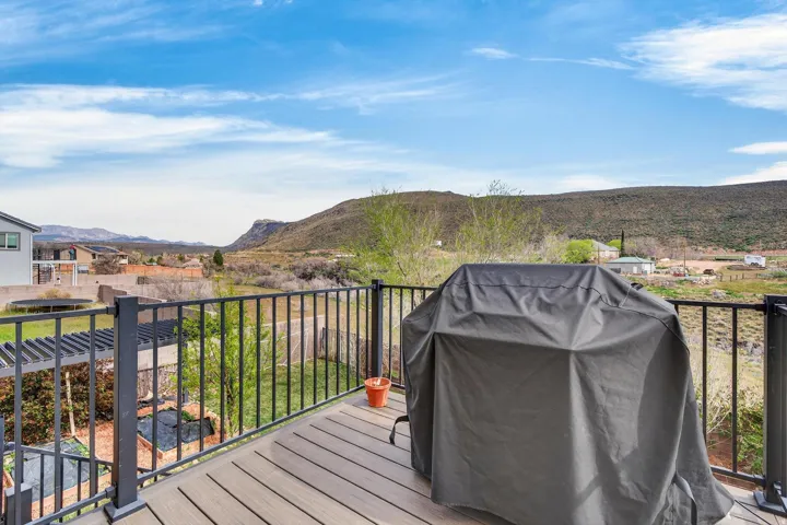 Outdoor deck featuring composite decking and black metal railings