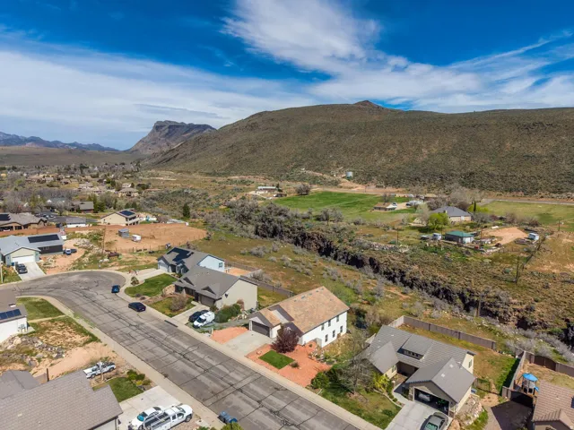 Residential street with multiple single-family homes, some featuring solar panels