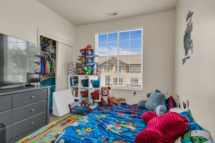 Neutral wall paint finishes a room with a window featuring horizontal blinds