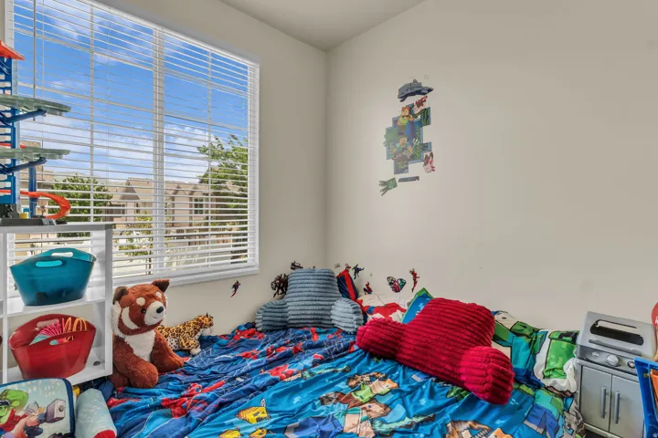 White-framed window with blinds, smooth white walls, and light-colored flooring