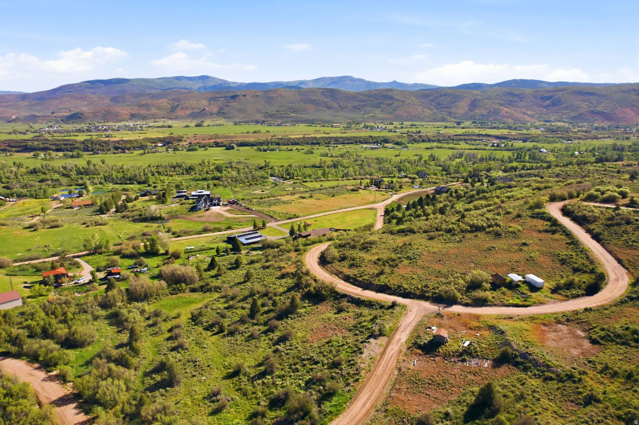 Expansive rural landscape featuring rolling hills and distant mountains