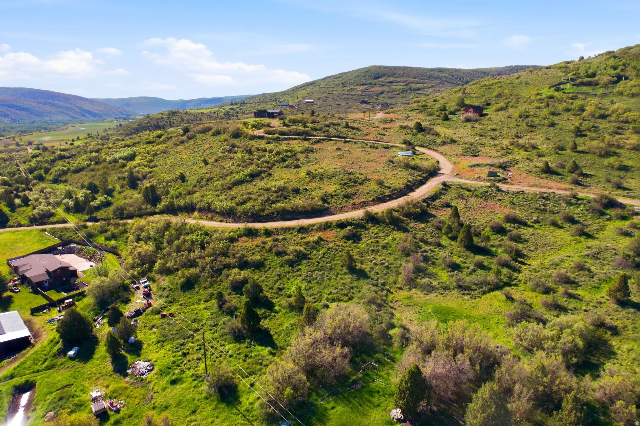 Expansive mountain landscape featuring varied topography, mature trees, and natural vegetation