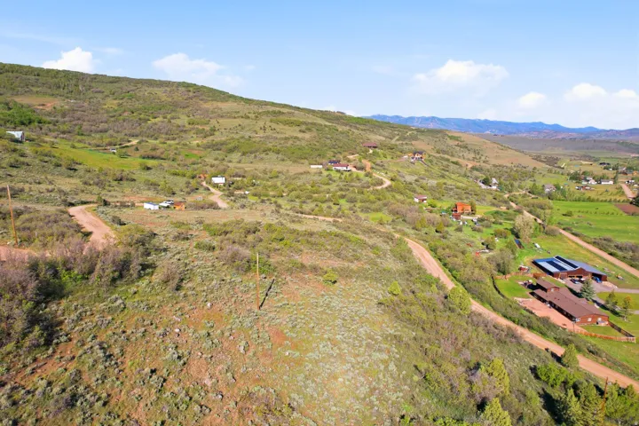 Expansive hillside acreage featuring natural vegetation and visible dirt roads