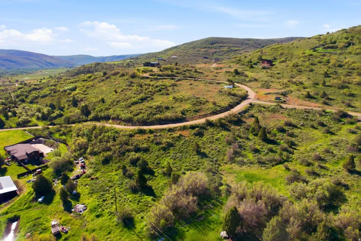 Expansive mountain landscape featuring varied topography, mature trees, and natural vegetation