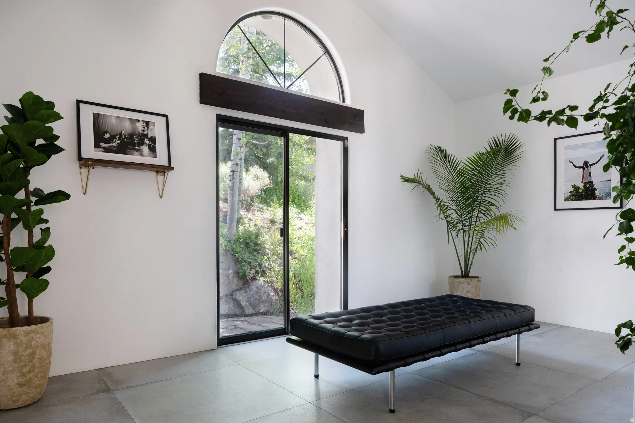 Arch-top window above a full-height sliding glass door