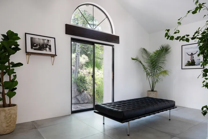 Arch-top window above a full-height sliding glass door