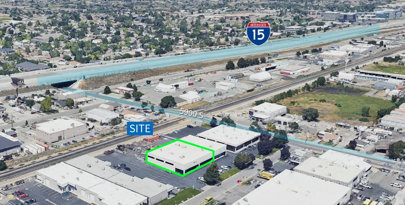 Commercial property featuring a flat roof and a paved parking area