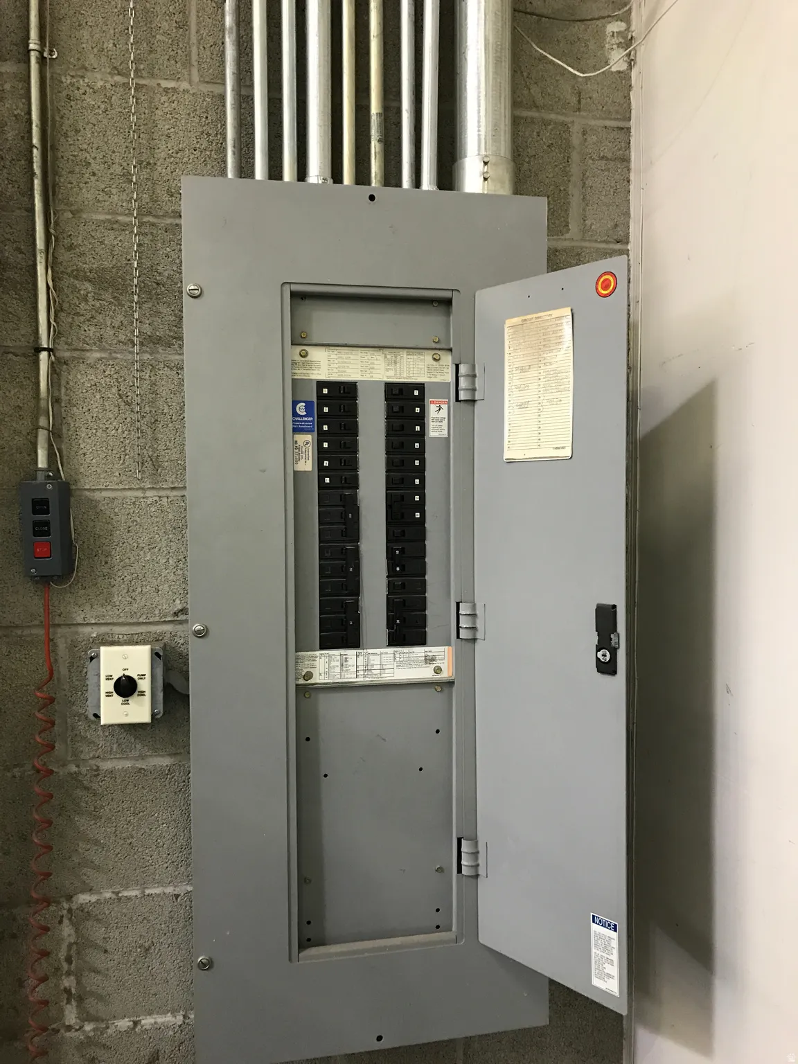 Electrical service panel featuring multiple circuits and exposed conduit