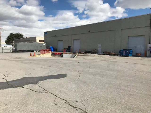 Industrial building with multiple bay doors and a loading dock with ramp access