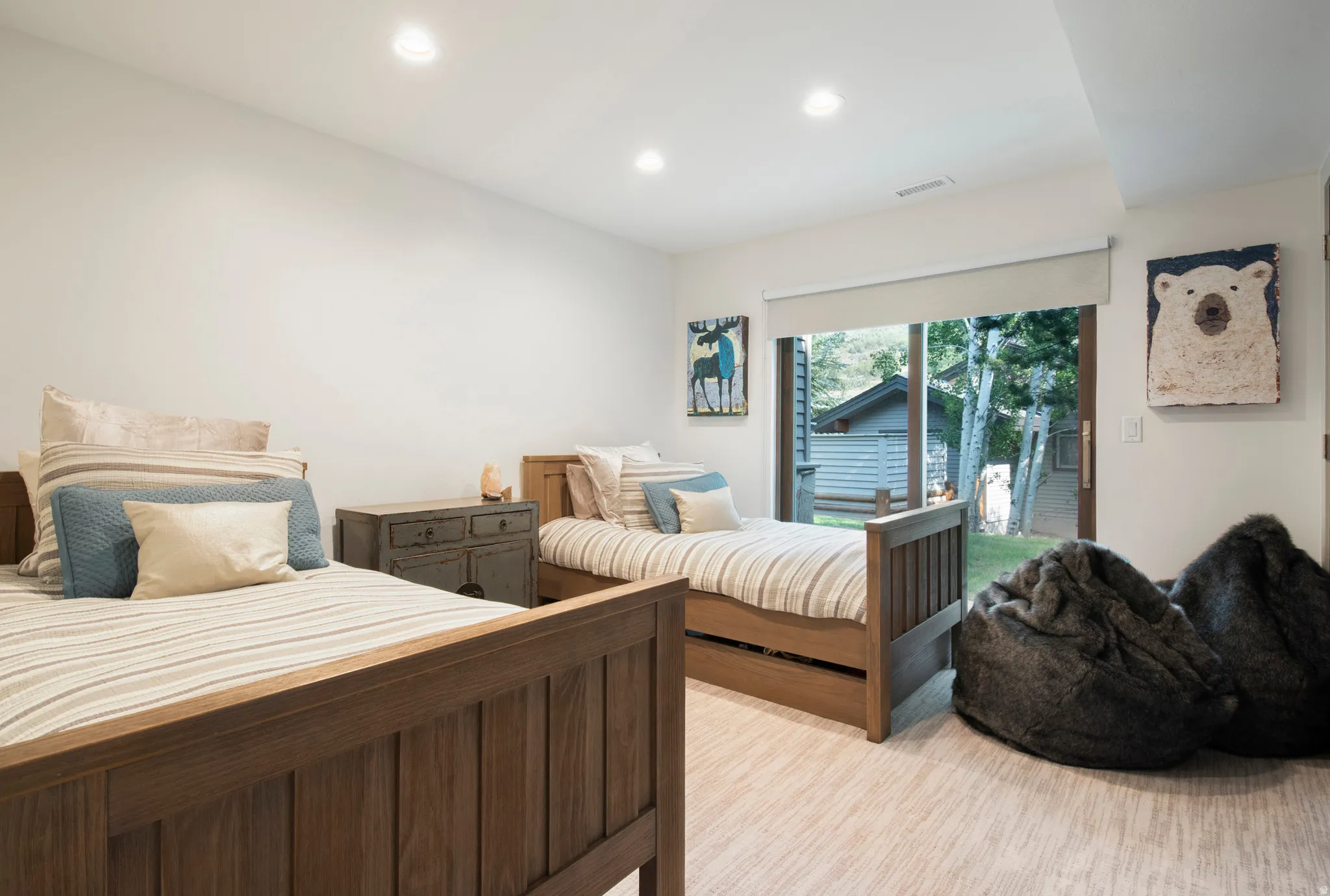 Expansive room featuring wood-finish flooring, recessed lighting, and a sliding glass door providing direct outdoor access