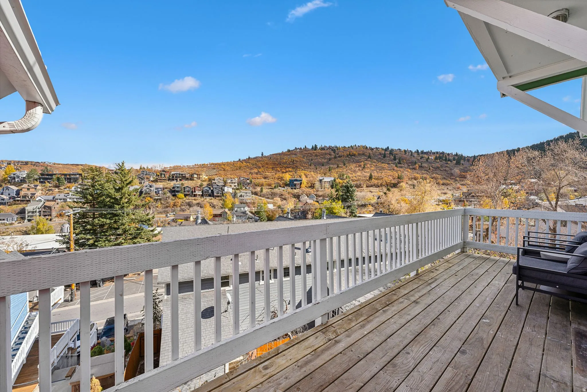 Spacious outdoor deck with wood flooring and white railing