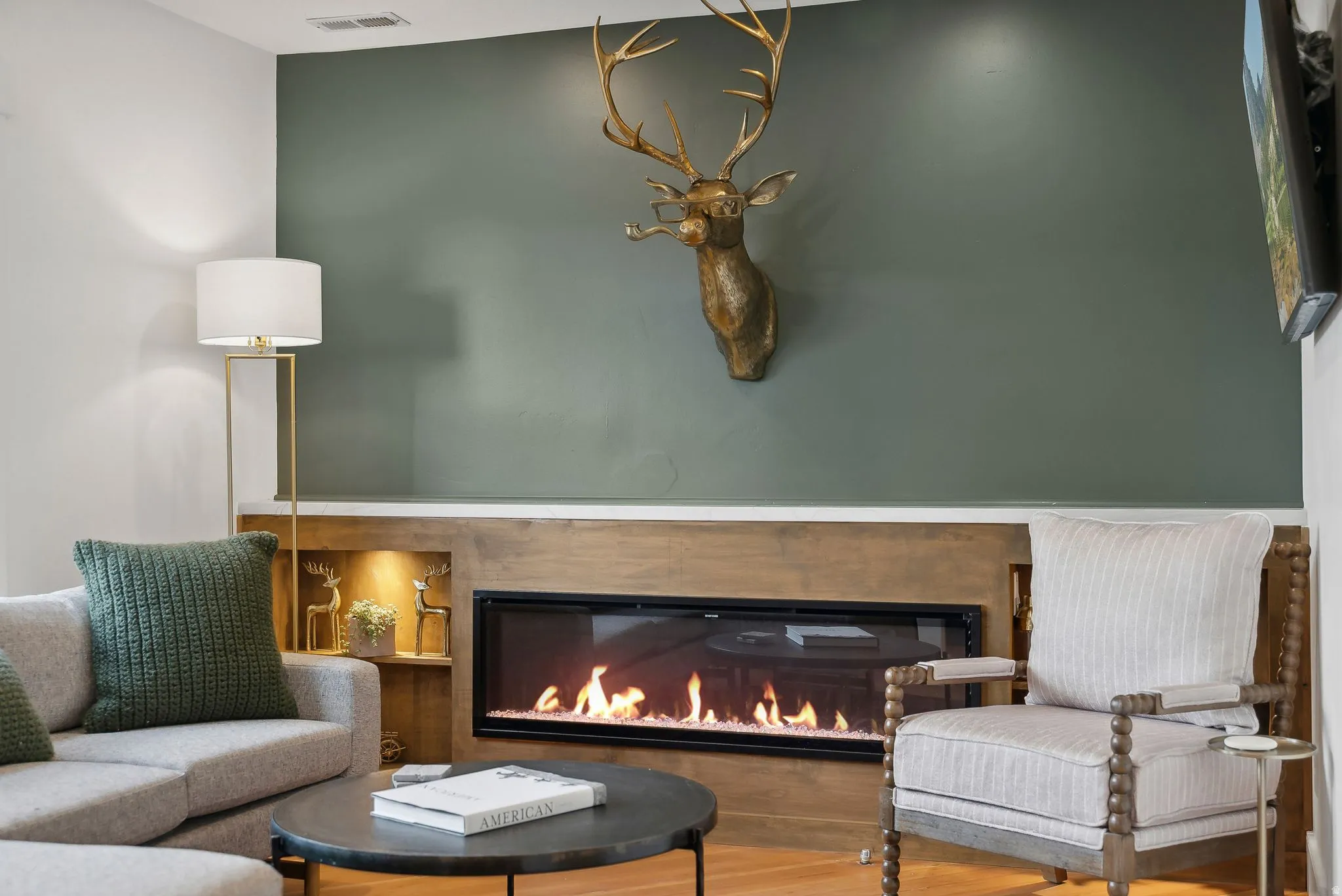 Modern linear fireplace with a wood-finish mantel and integrated accent lighting