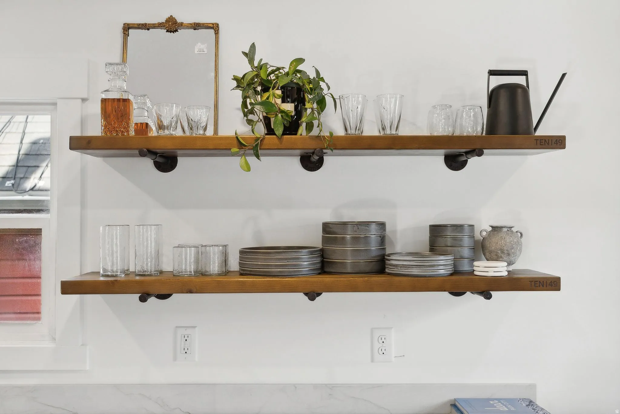 Open shelving with wood-finish planks and industrial-style pipe supports