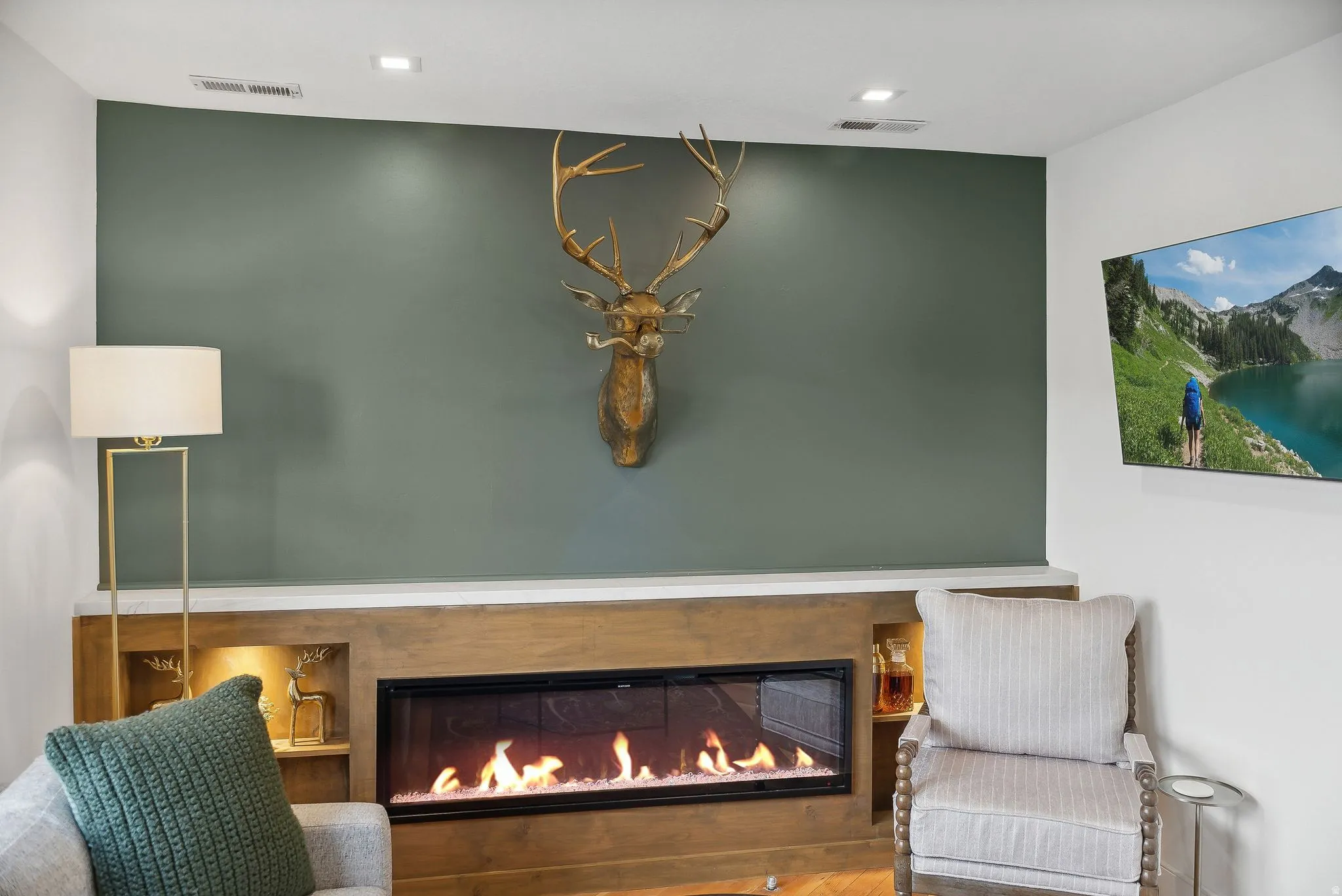Built-in linear fireplace with a light wood-finish surround and integrated shelving