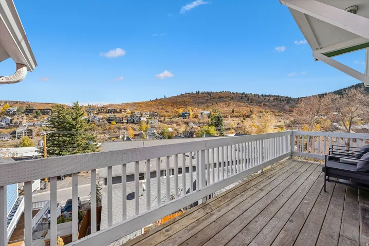 Spacious outdoor deck with wood flooring and white railing