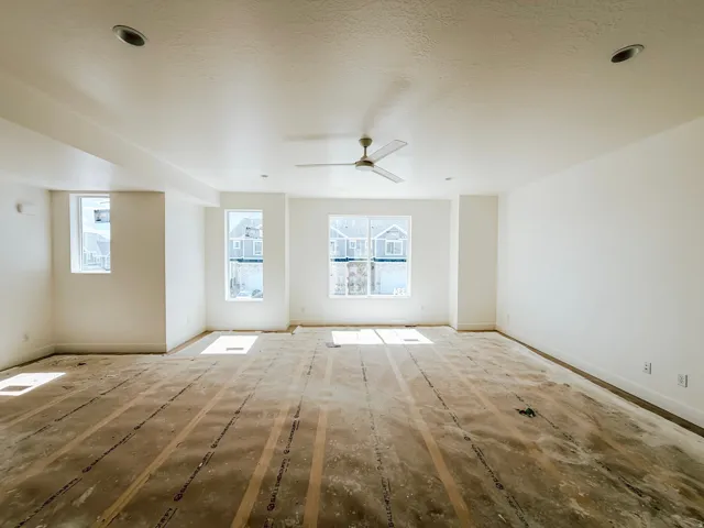 Spacious room featuring multiple windows, recessed lighting, and a ceiling fan