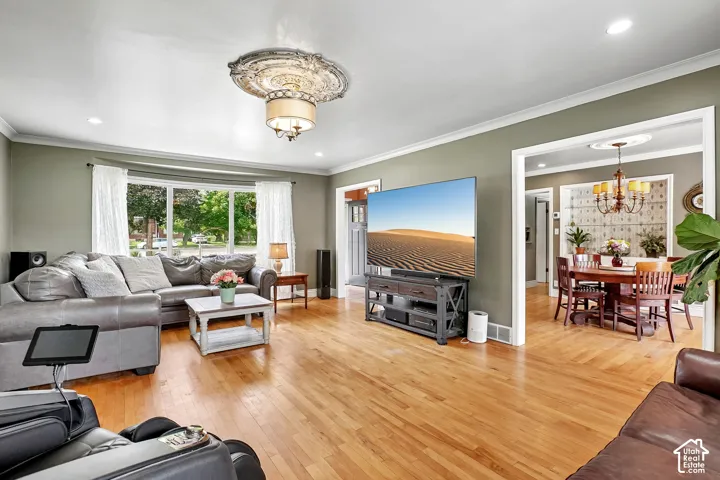 Spacious interior featuring wood-finish flooring and a decorative ceiling medallion with an attached chandelier
