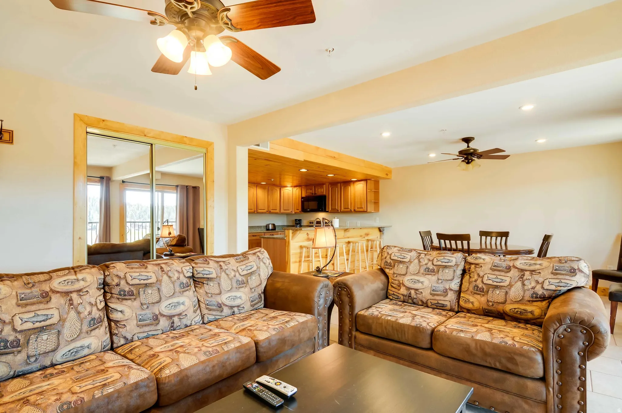 Open-concept living area featuring a ceiling fan with integrated lighting, recessed lighting, and light-toned walls