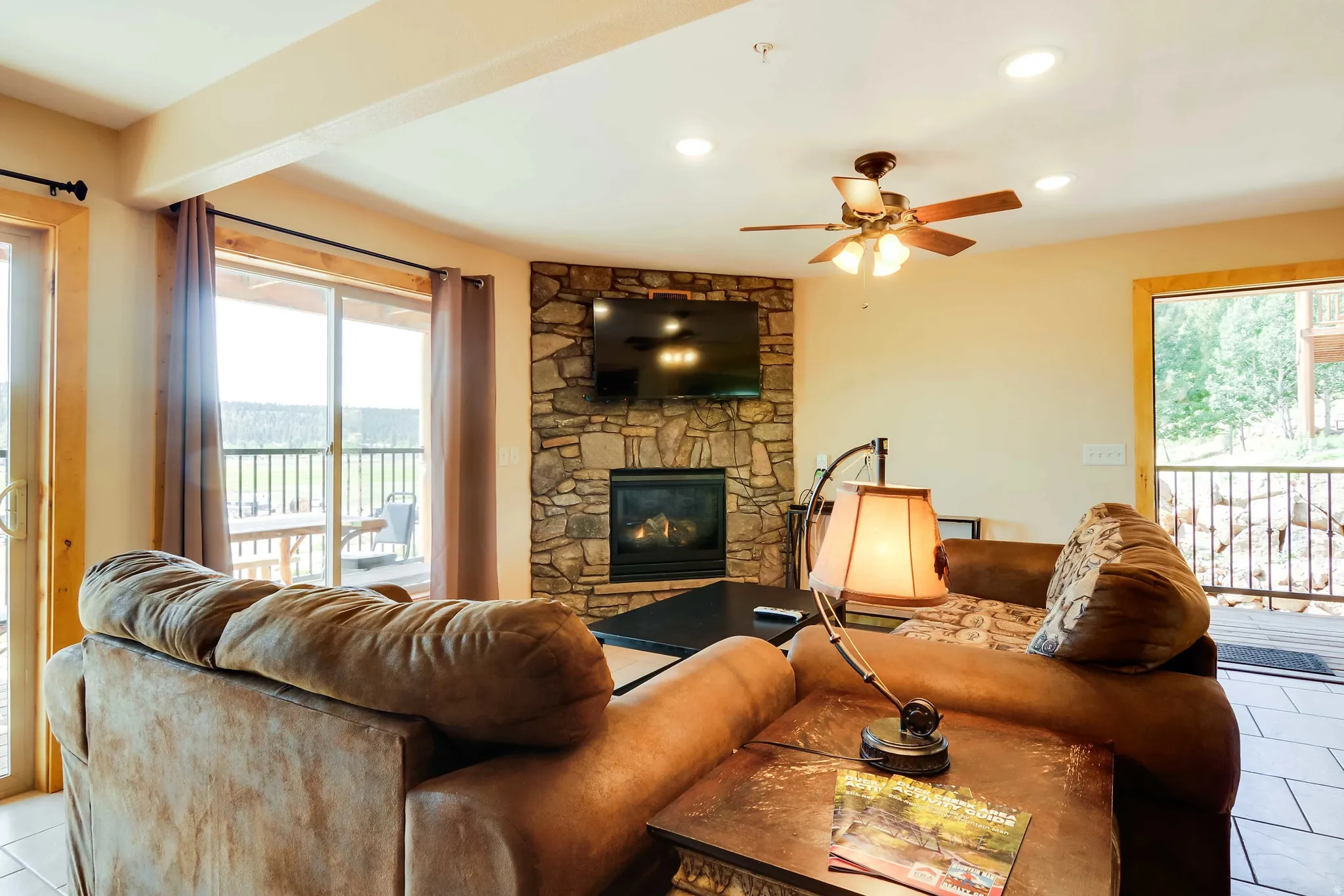 Living area with a stone-clad fireplace and gas insert