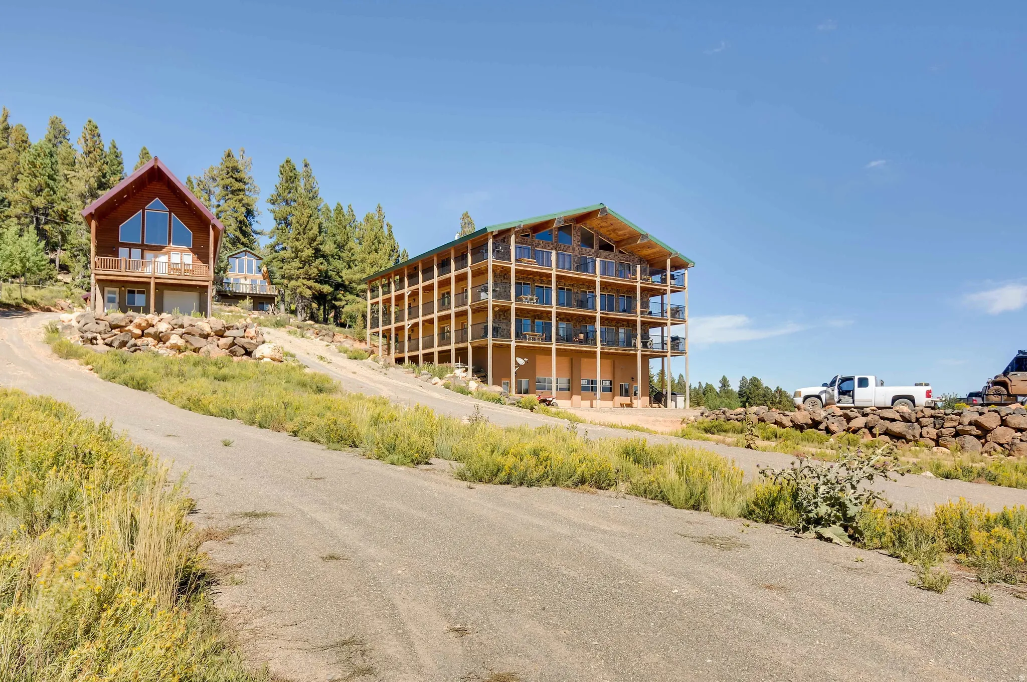 Multi-level property featuring wood-finish siding, extensive balconies, and large picture windows