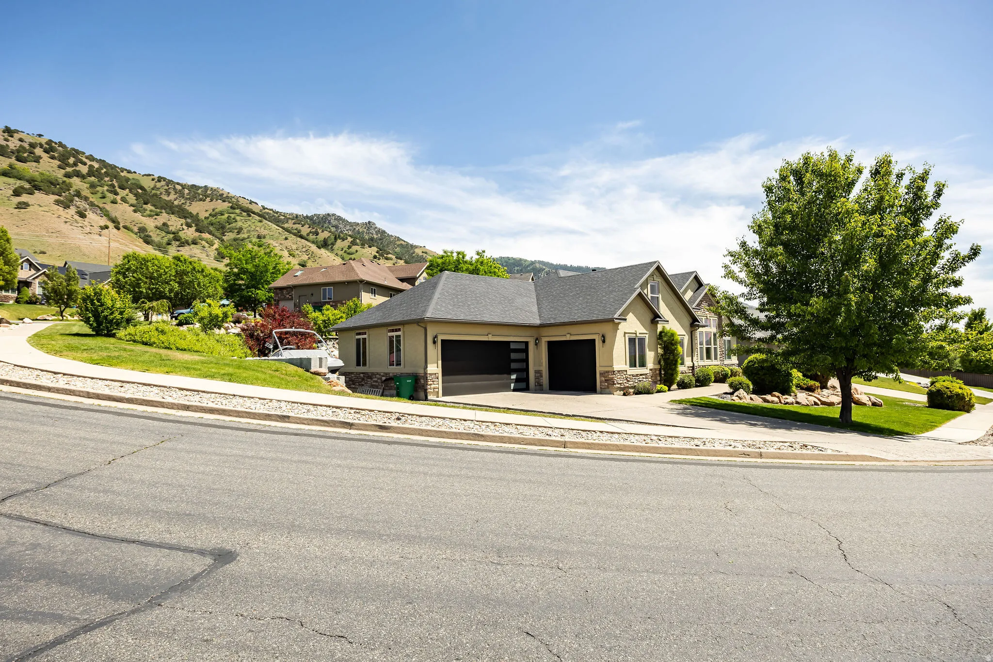 Single-story property with a light stucco exterior and stone veneer accents