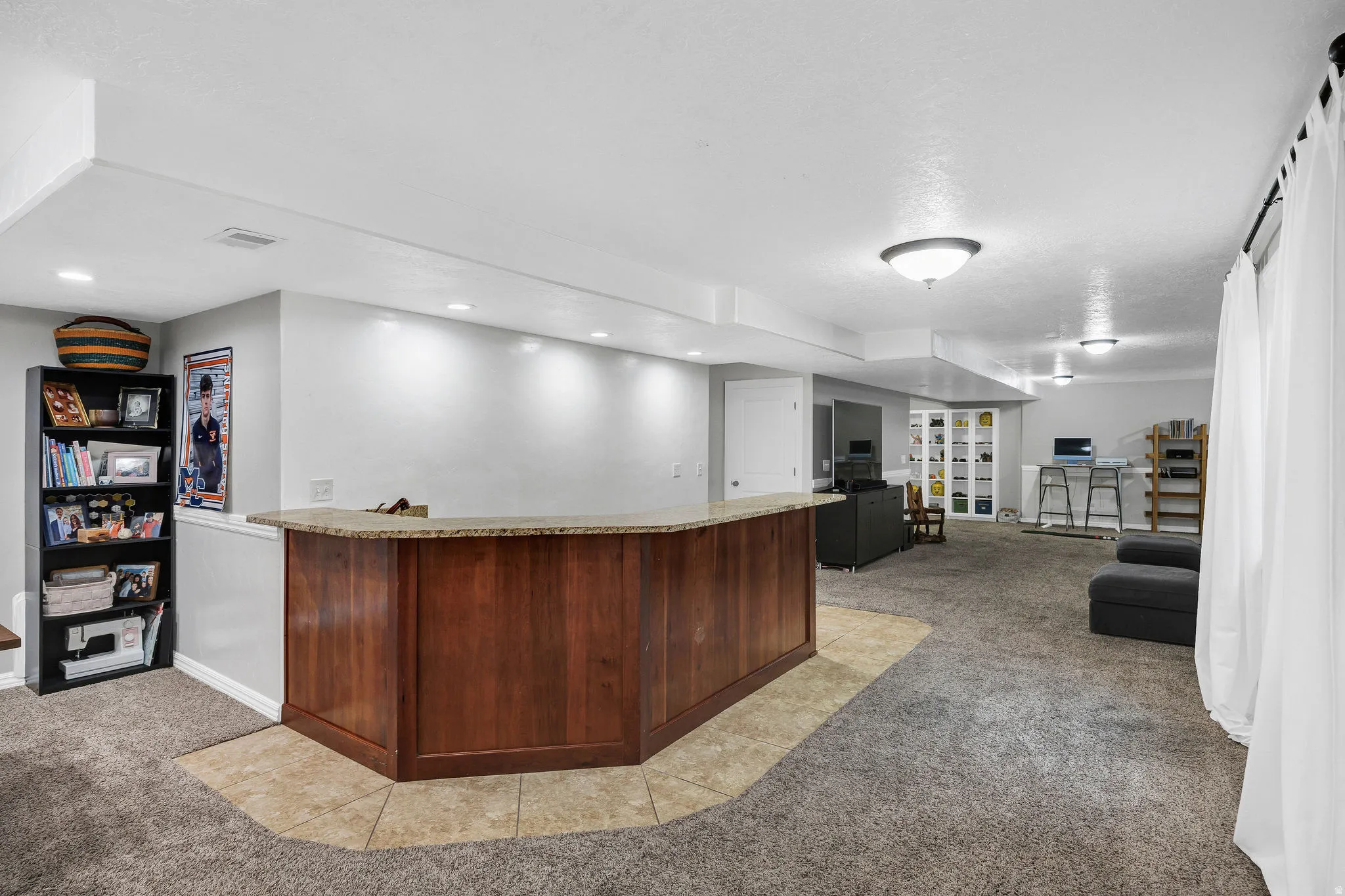 Built-in bar with wood-panel base and stone-finish countertop