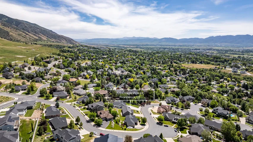 Residential neighborhood featuring established homes, mature trees, and paved roads