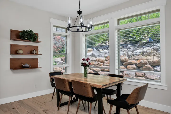 Dining area featuring wood-finish flooring and a contemporary chandelier