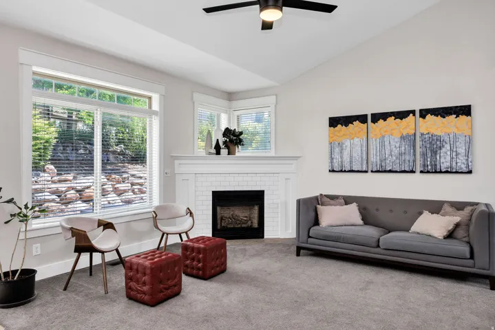 Living area featuring a contemporary fireplace with white subway tile surround and mantel