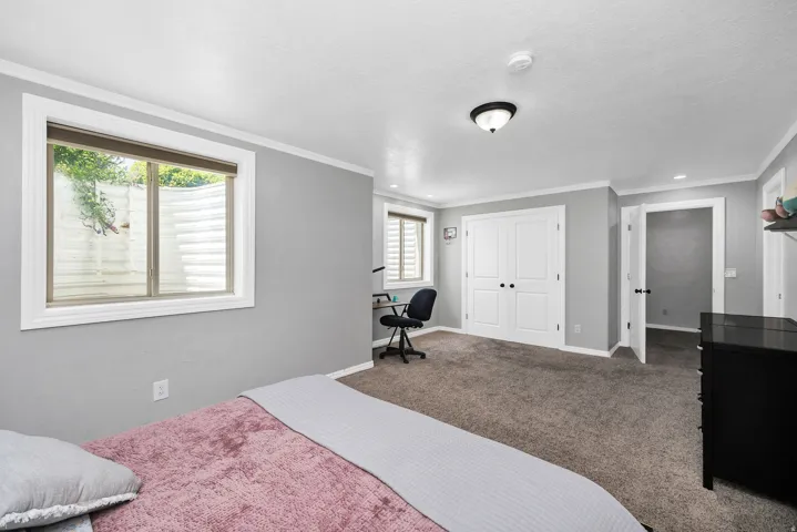 Spacious room featuring neutral carpeting and light gray walls