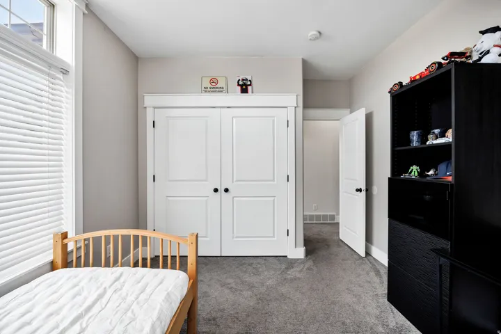 Neutral-toned walls complement the gray carpeting