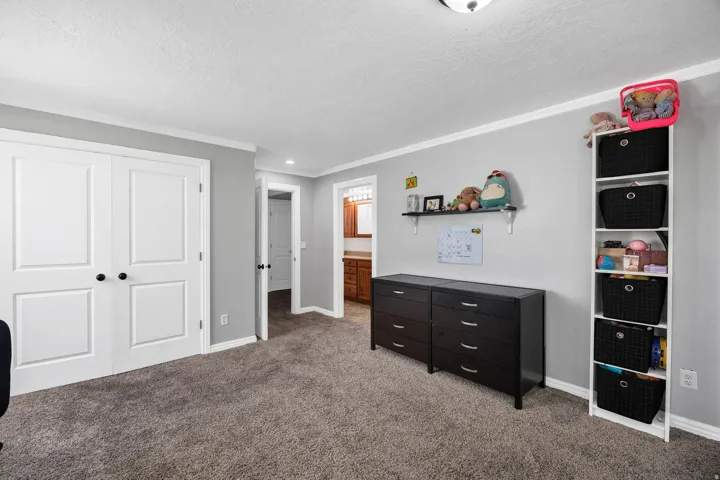 Room featuring gray wall paint, white baseboards, and white crown molding