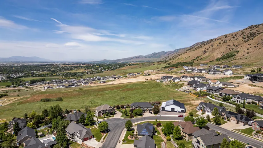 Aerial perspective showcasing a residential community nestled against a mountainous backdrop