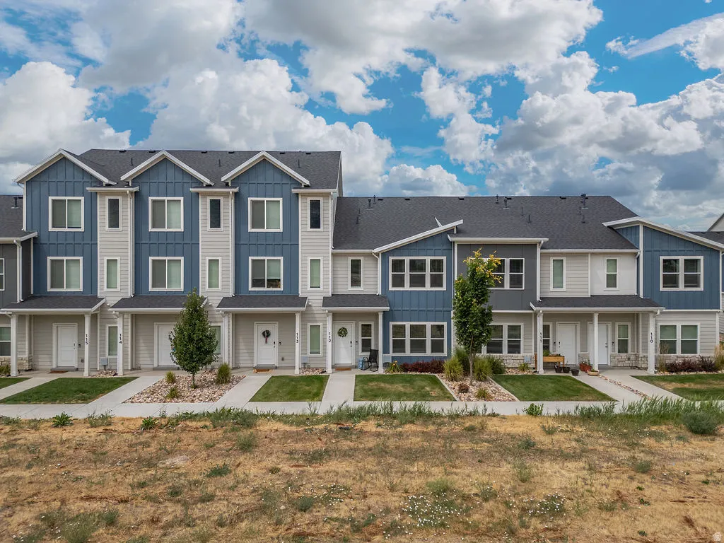 Contemporary townhome architecture featuring varied siding textures in shades of blue and light gray