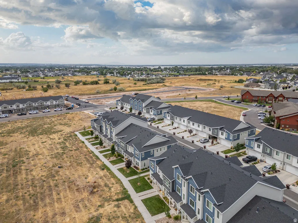 Contemporary townhomes featuring multi-tone siding, attached garages, and individual front walkways