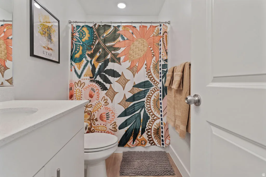Bathroom vanity with a light-toned countertop and integrated sink