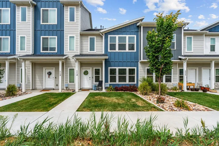 Modern townhome exteriors featuring horizontal siding, vertical paneling, and an angular roofline