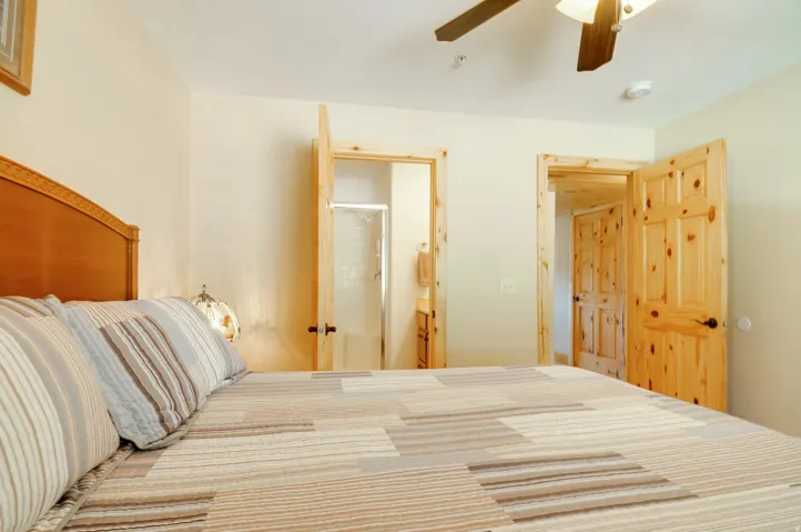 Bedroom featuring light-colored walls and knotty pine doors