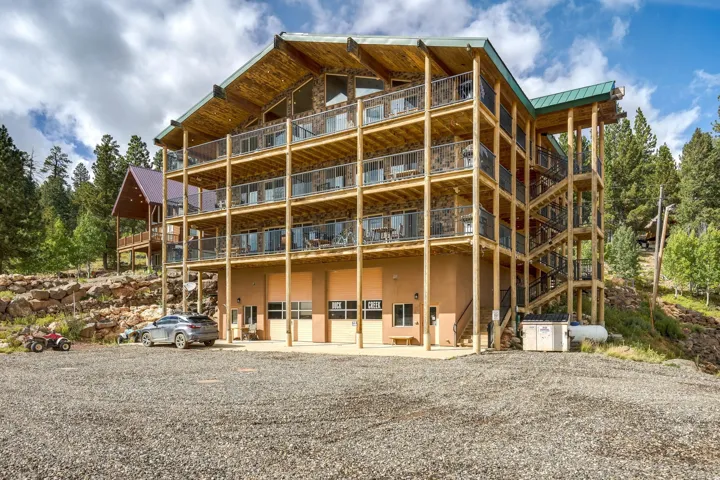 Multi-level structure featuring extensive wood beam construction and stone accents