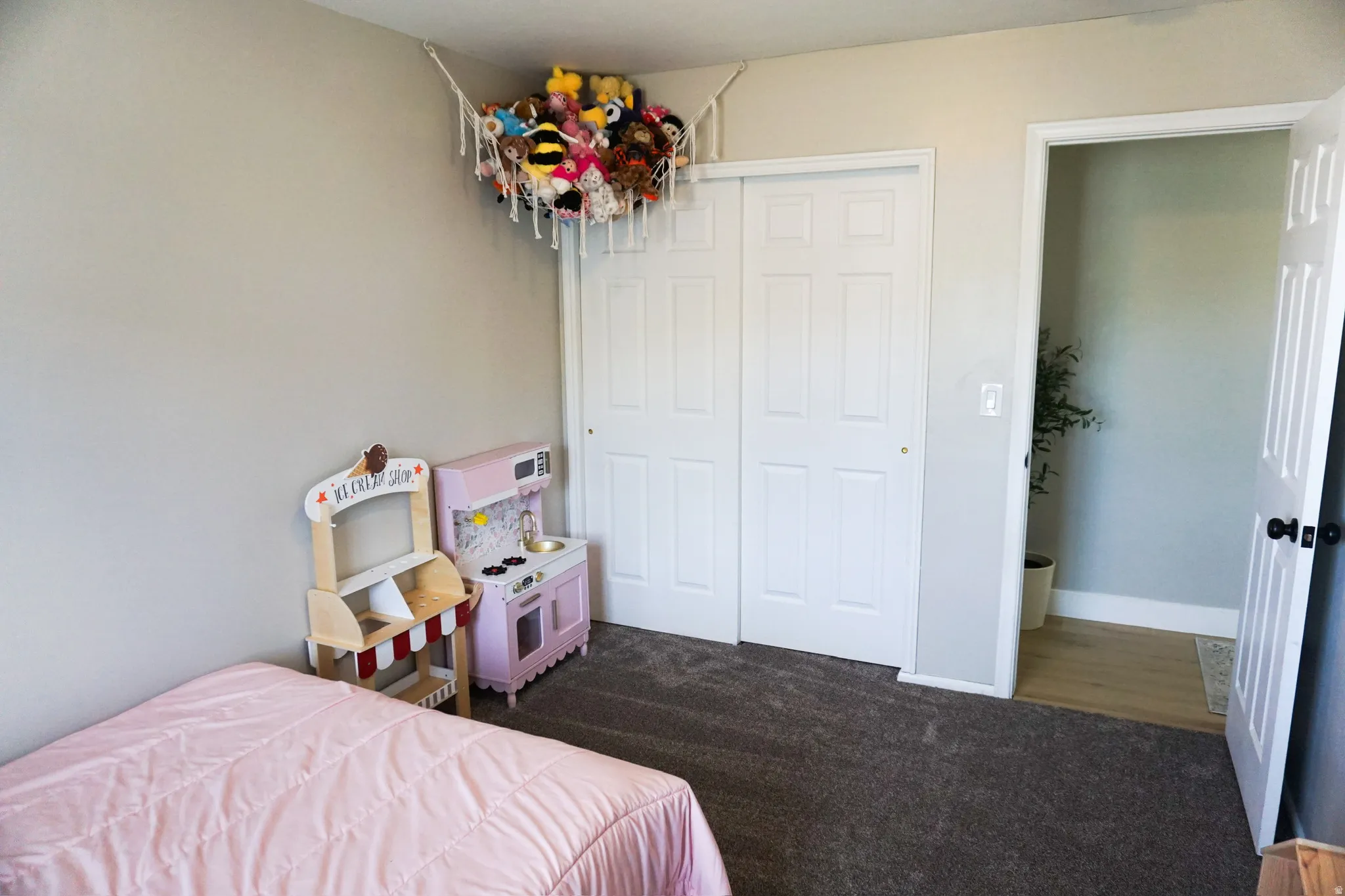 Carpeted room with a closet featuring bi-fold doors