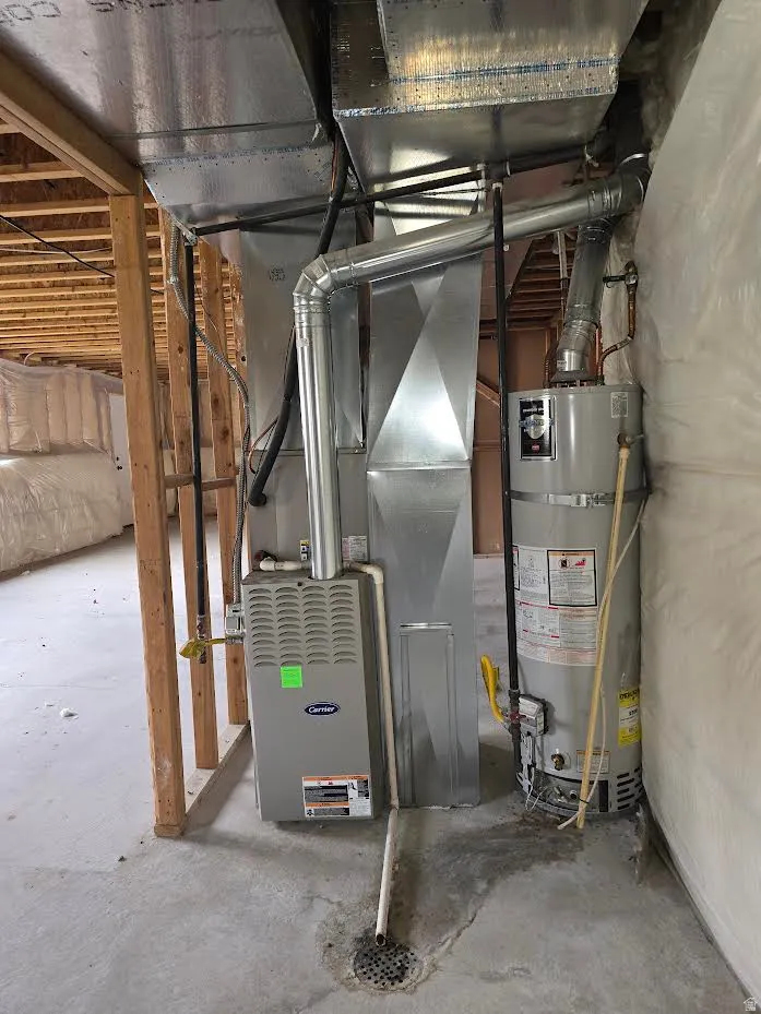 Furnace and water heater systems feature a concrete floor with a floor drain