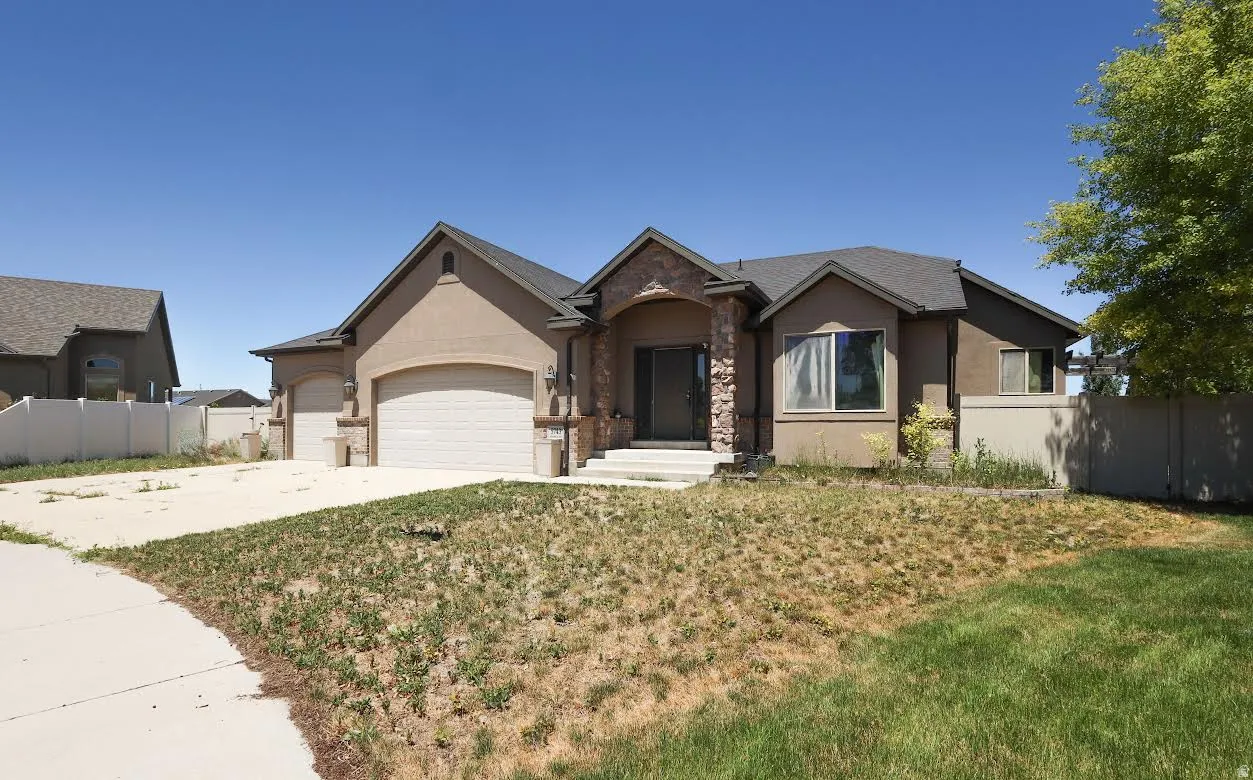 Stucco exterior with stone accents and a covered entry
