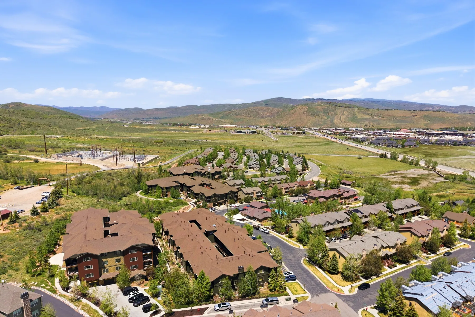 Aerial perspective of a developed residential area featuring multi-story buildings with brown roofs and diverse exterior colors