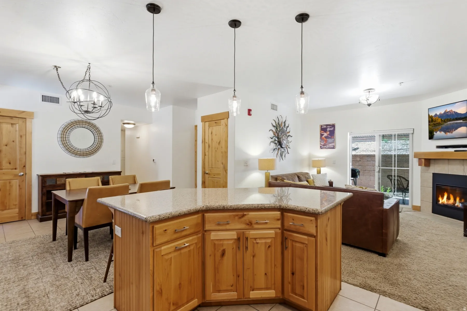 Kitchen island with granite countertop and pendant lighting