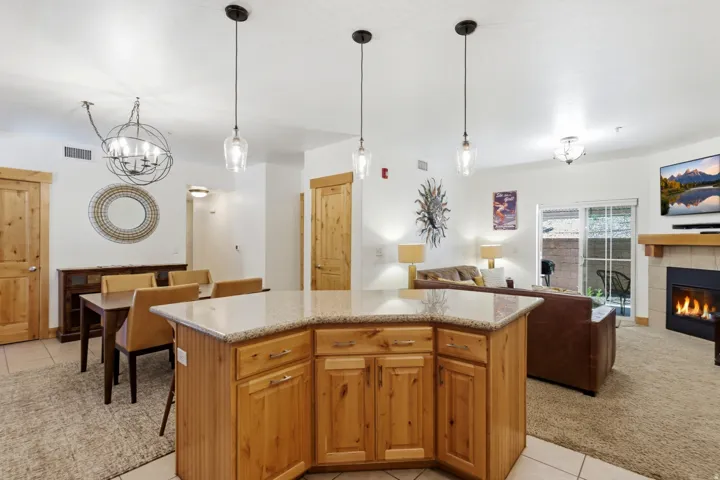 Kitchen island with granite countertop and pendant lighting