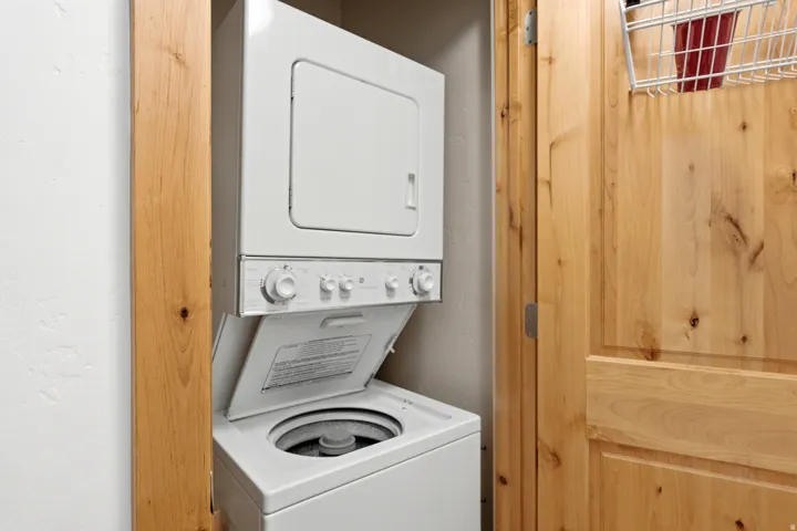 Stackable laundry appliances within a dedicated utility space